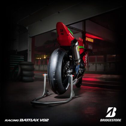 Red Suzuki motorcycle with Bridgestone tyres in back angle