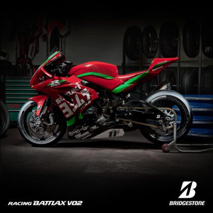 Red Suzuki motorcycle with Bridgestone tyres in side angle
